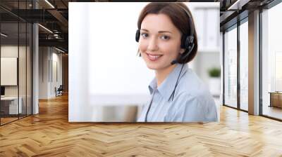  Young beautiful business woman in headset. Call center. Wall mural