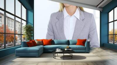 Blonde business woman examining contract while sitting at the glass desk in office background . Lawyer or secretary specialist at work Wall mural