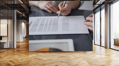 Business people signing contract papers while sitting at the glass table in office, closeup. Partners or lawyers working together at meeting. Teamwork, partnership, success concept Wall mural