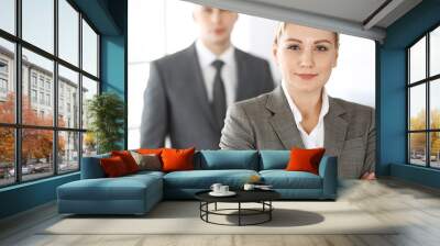 Business woman standing straight with colleague businessman in office, headshot. Success and corporate partnership concept Wall mural