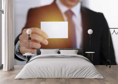 Businessman's hand holding business card with empty space, close-up  Wall mural