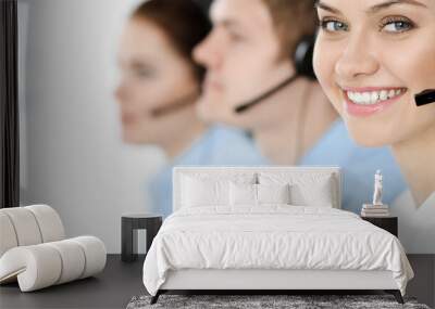 Call center. Diverse customer service operators in headsets at work in office. Business concept Wall mural