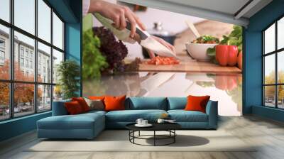 Close Up of human hands cooking vegetable salad in kitchen on the glass table with reflection. Healthy meal, and vegetarian food concept Wall mural