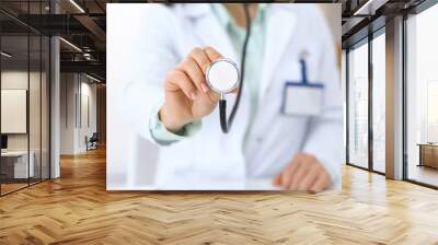 Doctor holds stethoscope head, close-up. Medical help and insurance in health care, best treatment and medicine concept Wall mural