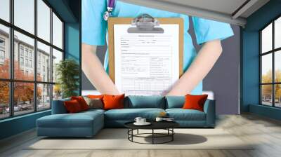 Female doctor holds medication history form while standing straight in hospital closeup. Healthcare, insurance and excellent service in medicine concept Wall mural