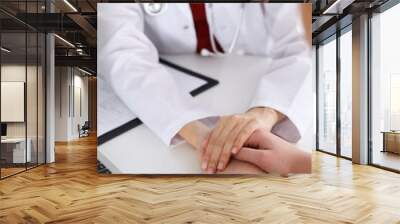 Hand of doctor  reassuring her female patient Wall mural