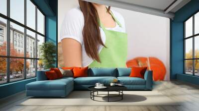 Young woman cooking in kitchen. Householding, tasty food and vegetarian in lifestyle concepts Wall mural