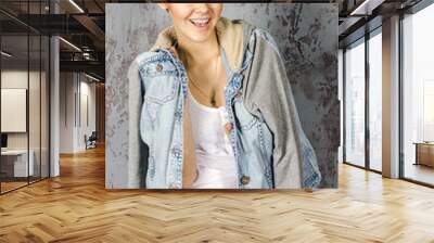 a young girl stands in denim jacket Wall mural