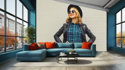 Fashion portrait of beautiful happy young woman, stylish girl smiling in black round hat posing Wall mural