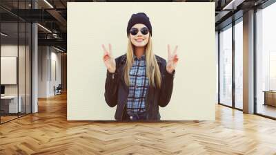 Fashion portrait of pretty blonde girl in trendy rock style posi Wall mural