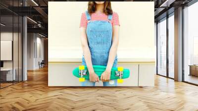 Fashion portrait pretty cool girl with skateboard over white bac Wall mural