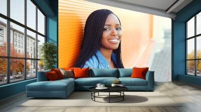 Portrait beautiful happy smiling african woman in city closeup Wall mural