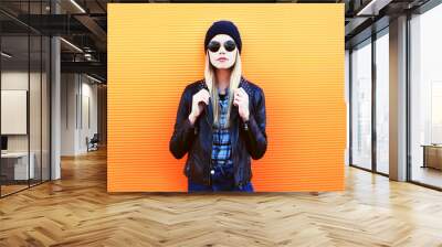 Portrait fashion blonde woman in rock black style over orange ba Wall mural