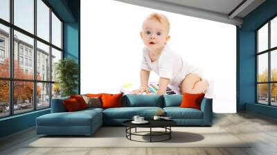 Portrait of curious baby playing with toy piano Wall mural