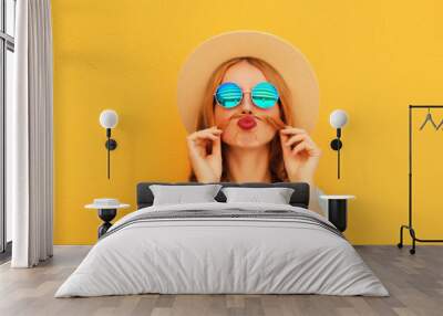 Portrait of funny young woman showing mustache her hair blowing lips wearing summer straw hat Wall mural