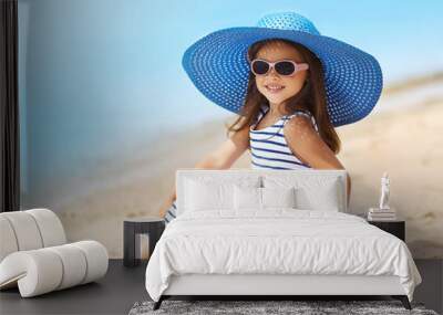 Portrait of pretty little girl in a striped dress and straw hat Wall mural