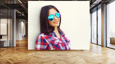 Portrait of pretty young woman in sunglasses over white backgrou Wall mural