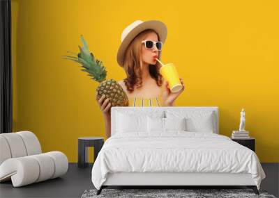 Summer portrait of stylish young woman drinking fresh juice with pineapple fruit Wall mural