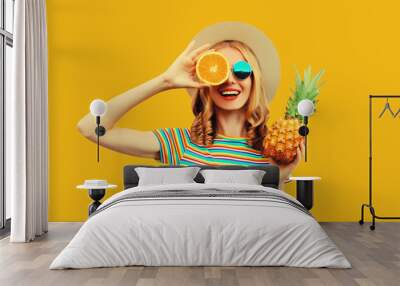 Summer vacation portrait of happy woman with fresh tropical juicy fruits on yellow background Wall mural