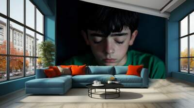 Young caucasian boy cries with eyes closed, showing deep sadness and vulnerability Wall mural