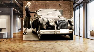 a beautiful blond woman getting into a classic car Wall mural