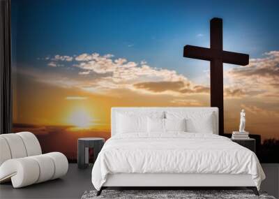 christian cross backlit from the evening sun and blue and orange sky Wall mural