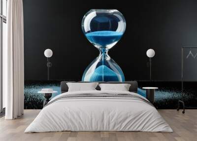 hourglass with blue sand on black background Wall mural