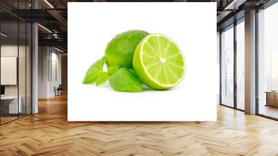 Fresh and ripe green lime whole and cut in half, vitamin rich fruit, exotic fruit isolated Wall mural