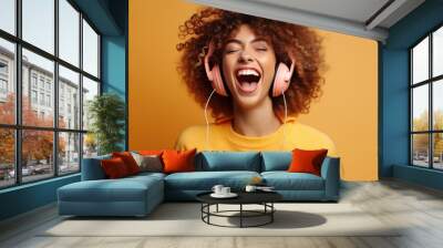 Thrilled millennial young lady wearing earphones have fun moving tuning in to music unwind in living room cheerful youthful lady in headphones move appreciate relaxation end of the week at domestic Wall mural