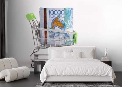 10000 Kazakhstani tenge in a shopping cart isolated on white background. Wall mural