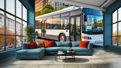 A public transit bus navigates a city street, showcasing its sleek design against the backdrop of residential buildings and lush trees as the sun sets Wall mural