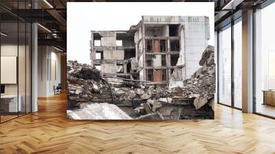 A ruined building against a gray sky with piles of concrete rubble and construction debris in the foreground. Background Wall mural