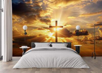 A solitary cross stands tall as the sun sets, casting rays of light through the clouds. The vibrant colors of dusk create a peaceful, spiritual atmosphere Wall mural