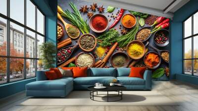 An array of spices and herbs is displayed on a textured surface, featuring bowls of red chili, turmeric, coriander, and fresh green leaves, perfect for enhancing dishes Wall mural