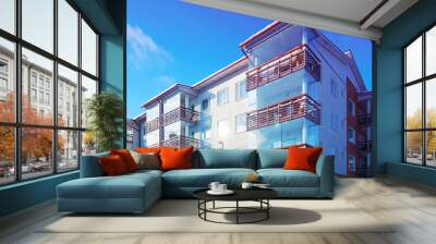 Apartment in residential building exterior. Housing structure at blue modern house of Europe. Rental home in city district on summer. Wall and glass high architecture for business property investment. Wall mural