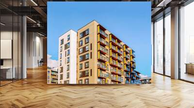 Fragment of Modern residential apartment and flat buildings exterior. Detail of New luxury house and home complex. Part of City Real estate property and condo architecture. Copy space. Blue sky Wall mural