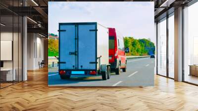 Mini van carrying trailer at asphalt road in Slovenia reflex Wall mural