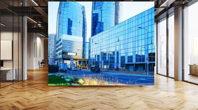 Street with Glass Business office building architecture and Modern City Center. Urban corporate skyscraper exterior and skyline. Blue sky on background. Cityscape with futuristic view concept design Wall mural