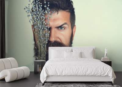 Beauty natural portrait of brutal bearded man with flowers purple lavender. Fashion man with flowers. Style model face with lavender. Male face isolated on white background. Perfect skin, beard, hair Wall mural