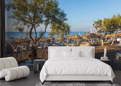 Perivolos beach on Santorini island in Greece at sunrise. The background is a blue sky with white clouds. Wall mural