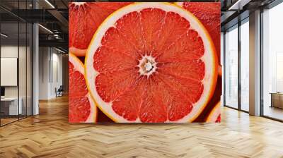 Bright red grapefruit slices showcase their juicy segments, ready for a refreshing snack or garnish in a vibrant kitchen environment Wall mural