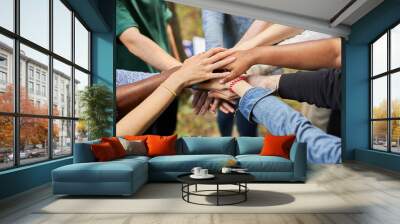 close-up photo of diverse people's hands gathered together, african american and caucasian people as one union. various ethnicities are friends all over the world Wall mural