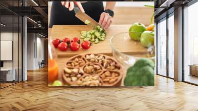 Close-up photo of female hands with knife cutting fresh vegetables Wall mural