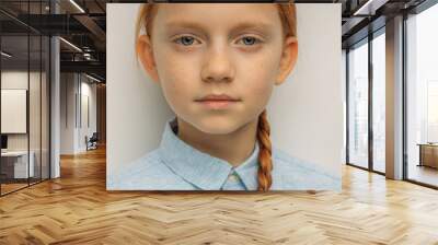 close-up portrait of serious caucasian child girl with long red hair isolated over white background. natural red haired girl with freckles seriously look at camera Wall mural