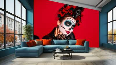 Closeup photo of funny folklore witch creature character death day facial creepy makeup masquerade. Sugar skull girl take selfies wear floral headwear amd lether jaket isolated on red background Wall mural