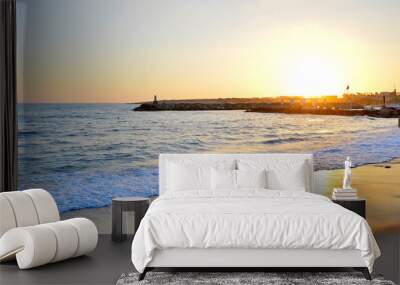 Orange sunset on the deserted beach of the Mediterranean sea Wall mural