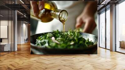 Pouring olive oil onto fresh arugula salad with almonds Wall mural