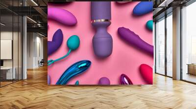 purple big phallus among small sex toys isolated on pink background, a lot of bright vobrators lie on pink paper, toys for relaxation and pleasure, romantic time. sex shop concept Wall mural