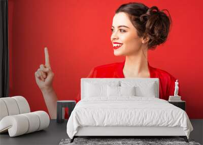 Emotional brunette girl on a red background Wall mural