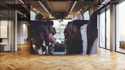 The tourist bus interior with people sitting Wall mural